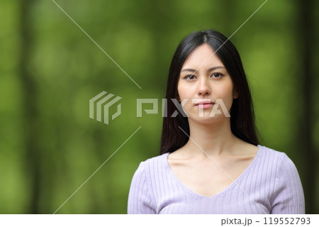 Serious asian woman looking at you on green Serious asian woman looking at you on green 119552793
