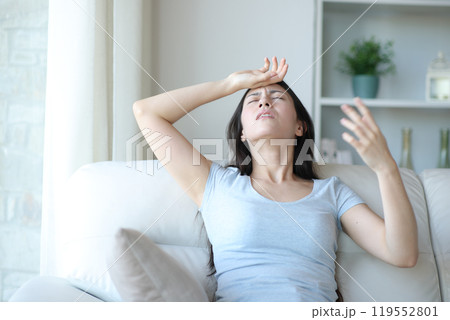 Stressed asian woman suffering heat stroke at home Stressed asian woman suffering heat stroke at home 119552801