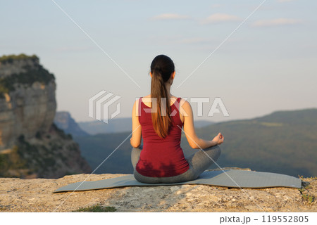 Woman doing yoga exercise in the mountain 119552805