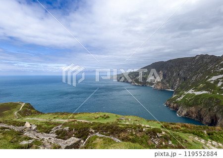Coastal cliffs of Slieve League stretching along the Atlantic with rolling green hills 119552884