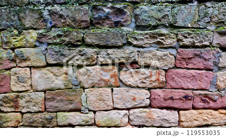 Textured Brick Wall With Varying Hues and Patches of Moss in a Natural Setting Textured Brick Wall With Varying Hues and Patches of Moss in a Natural Setting 119553035