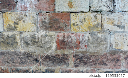 Textured Brick Wall With Various Colors and Weathered Stones in Close-Up Textured Brick Wall With Various Colors and Weathered Stones in Close-Up 119553037