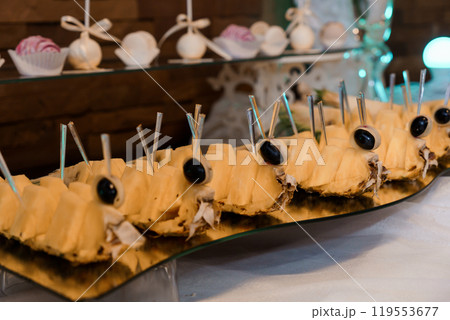 Exquisite Display of Dessert Pineapple Boats with Olive Garnish 119553677