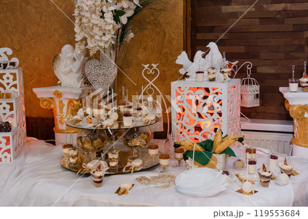 Elegant Dessert Table with Sophisticated Decorations and Assorted Treats 119553684