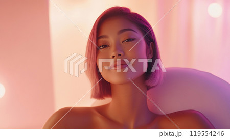 Pink bob hairstyle model in minimalistic hair salon setting with soft lighting. 119554246