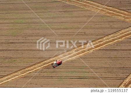 Aerial View : combine harvester working in the fields 119555137