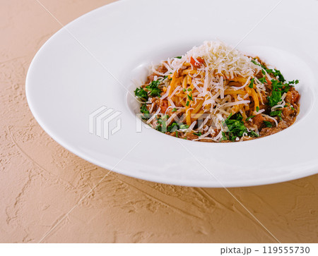 Gourmet spaghetti bolognese with parmesan on white plate Gourmet spaghetti bolognese with parmesan on white plate 119555730