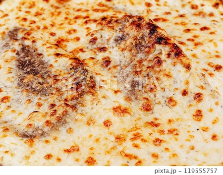 Delicious lasagna with bechamel sauce and melted cheese baking in the oven Delicious lasagna with bechamel sauce and melted cheese baking in the oven 119555757