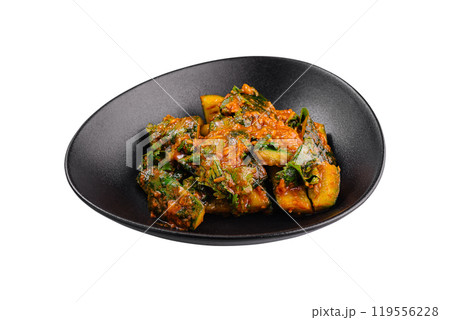 Spicy fried bitter melon with chili garlic sauce on black plate Spicy fried bitter melon with chili garlic sauce on black plate 119556228