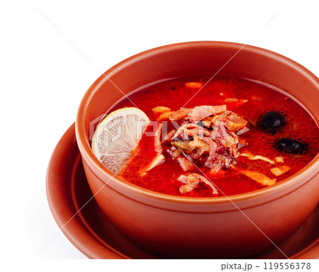 Russian traditional solyanka soup with meat and lemon in bowl Russian traditional solyanka soup with meat and lemon in bowl 119556378