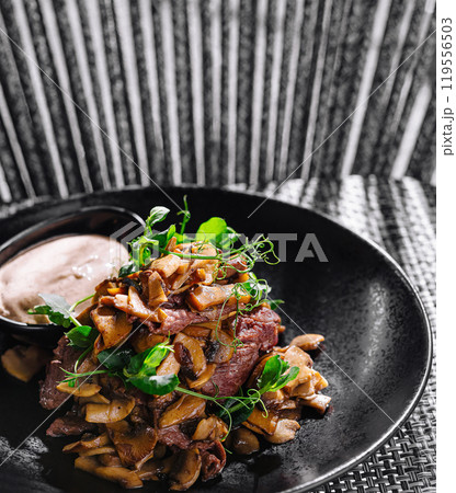 Gourmet fried mushrooms with beef steak and dip on elegant plate Gourmet fried mushrooms with beef steak and dip on elegant plate 119556503