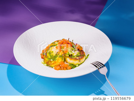 Salmon tartare with avocado and zucchini pancakes on a designer plate 119556679