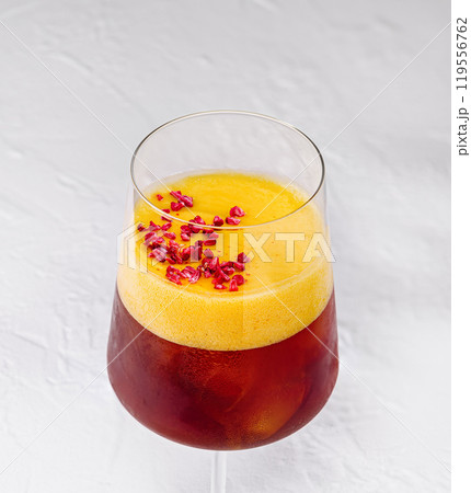 Yellow cocktail standing on white background with shadow 119556762