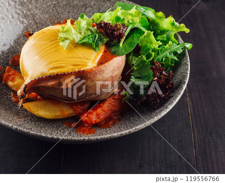 Chicken breast stuffed with cheese and bacon being served on gray plate Chicken breast stuffed with cheese and bacon being served on gray plate 119556766