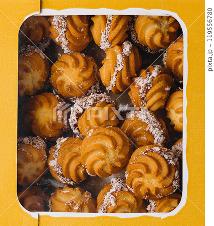 Assorted shortbread cookies on vibrant yellow background 119556780