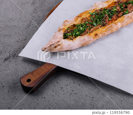 Fresh turkish pide on wooden serving board Fresh turkish pide on wooden serving board 119556790