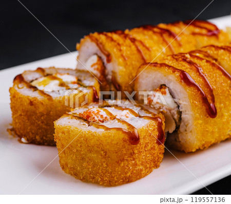 Delicious tempura maki sushi rolls being served on white plate Delicious tempura maki sushi rolls being served on white plate 119557136