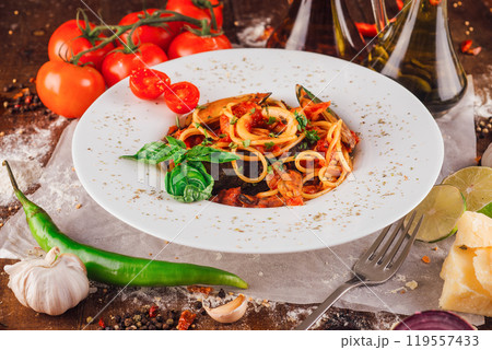 Delicious seafood pasta dish with mussels and squid being served on restaurant table 119557433