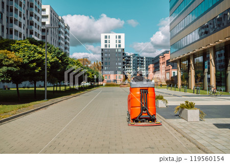 Cityscape of a residential area with modern apartment buildings, new green urban landscape in the city.Street cleaner, road sweeper cleaning on the floor in city of Krakow, Poland.  119560154