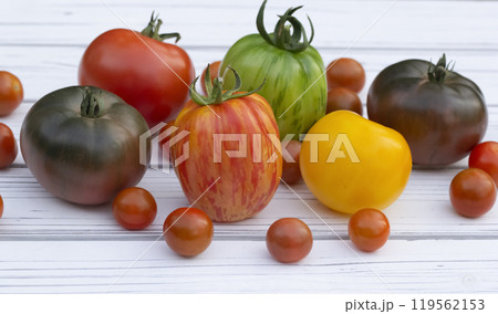 Variety of colorful tomatoes on the white wooden rustic table. 119562153