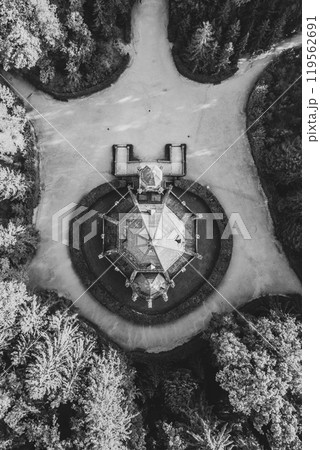 The historic Schwarzenberg Tomb stands out among lush greenery in Domanin near Trebon. This stunning structure features intricate architecture surrounded by paths. Black and white photography. 119562691