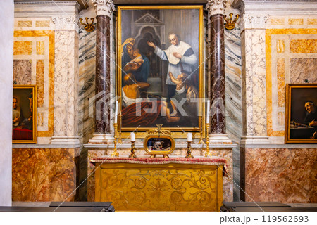 The altar within the Basilica of Santa Maria in Cosmedin displays the remains of Saint Valentine, surrounded by ornate decorations and religious artwork in a historic Roman setting. The altar within the Basilica of Santa Maria in Cosmedin displays the remains of Saint Valentine, surrounded by ornate decorations and religious artwork in a historic Roman setting. 119562693