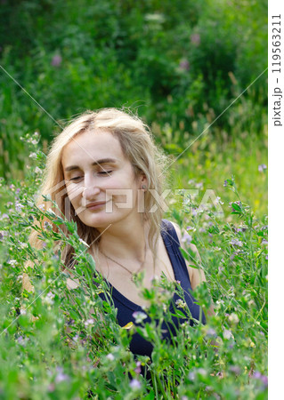 Woman with natural beauty enjoying nature in summer park. Woman with natural beauty enjoying nature in summer park. 119563211
