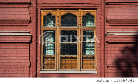 A large, wooden, old window of an old, red-brick building in Moscow A large, wooden, old window of an old, red-brick building in Moscow 119564345
