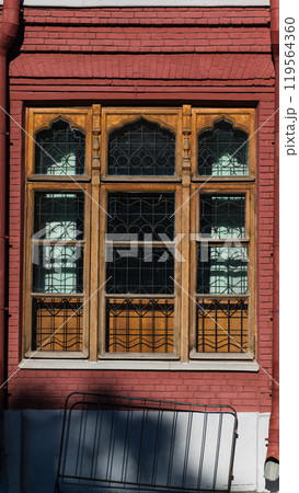 A large, wooden, old window of an old, red-brick building in Moscow A large, wooden, old window of an old, red-brick building in Moscow 119564360