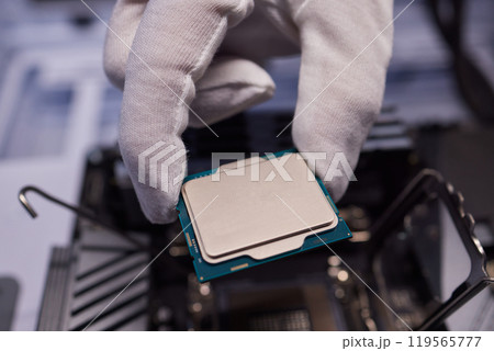 Cropped image of an engineer showing a computer microchip on the foreground Cropped image of an engineer showing a computer microchip on the foreground 119565777