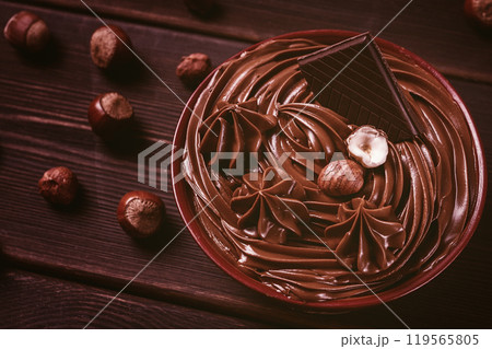 Chocolate nut paste, mousse, pasta, in a cup, on a wooden table, top view, selective focus, no people, 119565805