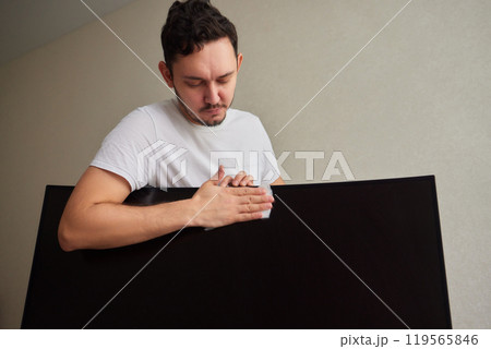 cleaning pc monitor an hand hold a rag 119565846