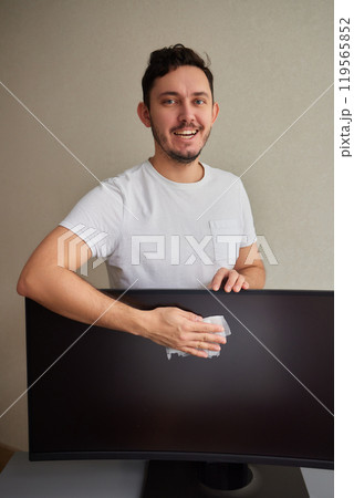 cleaning pc monitor an hand hold a rag 119565852