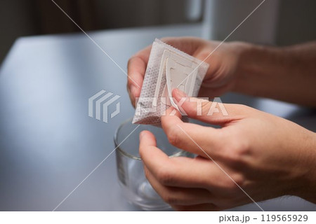 brewing process,a bag filled with boiling water for drip coffee in a cup,top view. 119565929