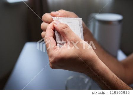 brewing process,a bag filled with boiling water for drip coffee in a cup,top view. brewing process,a bag filled with boiling water for drip coffee in a cup,top view. 119565936