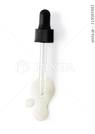 Drop falls from a pipette into a cosmetic bottle 119565981