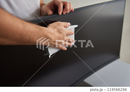 cleaning pc monitor an hand hold a rag cleaning pc monitor an hand hold a rag 119566298