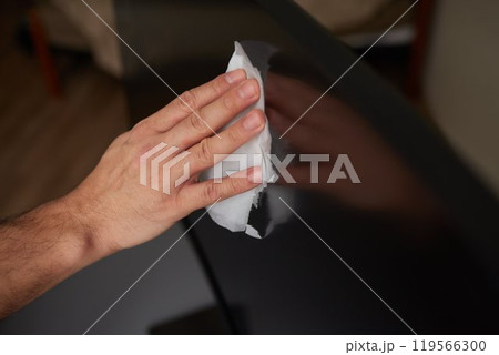 cleaning pc monitor an hand hold a rag 119566300