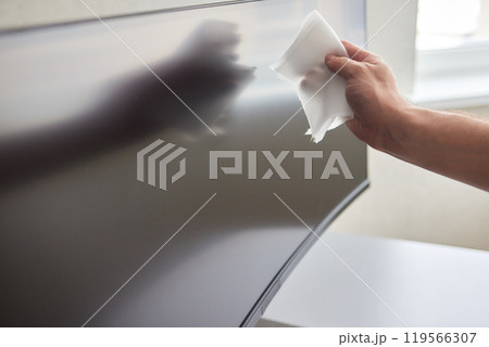 cleaning pc monitor an hand hold a rag cleaning pc monitor an hand hold a rag 119566307