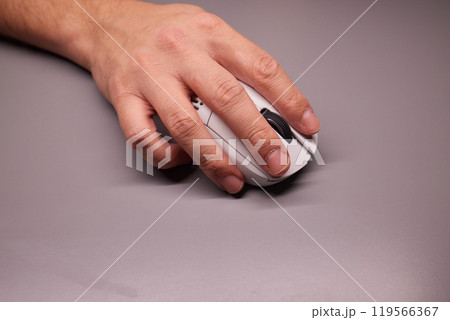 Close-up Macro Shot: Person's Hand Using Wireless Computer Mouse, Scrolls through Apps and Websites with a Wheel and Clicks on Buttons 119566367
