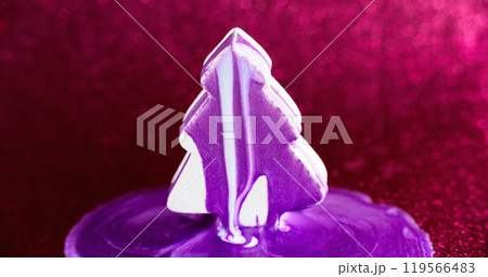 Paint fir tree. Xmas decoration. Purple white color shimmering ink drip spill over abstract conifer shape on defocused pink bokeh light background. 119566483
