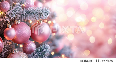 close-up of a Christmas tree adorned with pink ornaments and frosted branches 119567520