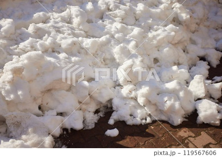 A thick layer of fresh snow covers a brick road surface during the winter season A thick layer of fresh snow covers a brick road surface during the winter season 119567606
