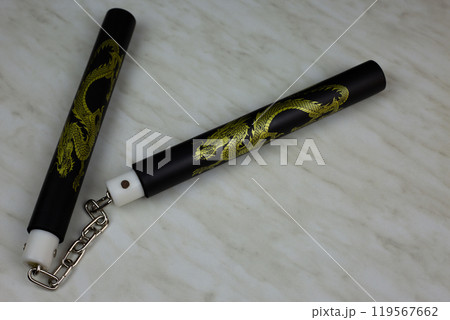 Soft foam rubber training nunchucks with steel chain, training martial arts at home using edged weapons, nunchucks for self defense training on white background Soft foam rubber training nunchucks with steel chain, training martial arts at home using edged weapons, nunchucks for self defense training on white background 119567662