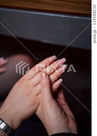 A photo capturing the intimacy and affection in two hands holding closely together 119568232