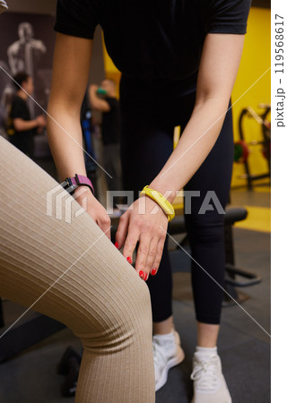 Women are engaging in stretching exercises at the gym as part of their fitness and workout routine 119568617