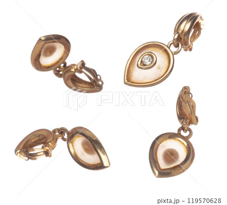 Fashion gold Earrings with beautiful work detail is value. Luxury golden earring is fashion trend and fly in air. White background isolated Fashion gold Earrings with beautiful work detail is value. Luxury golden earring is fashion trend and fly in air. White background isolated 119570628