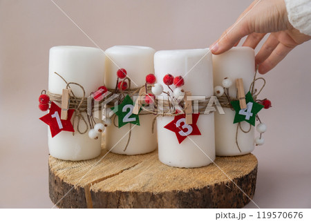 DIY process of woman making Christmas arrangement of advent candle calendar four weeks. Series of handmade craft instruction. Zero waste eco-friendly winter holiday decoration. DIY process of woman making Christmas arrangement of advent candle calendar four weeks. Series of handmade craft instruction. Zero waste eco-friendly winter holiday decoration. 119570676