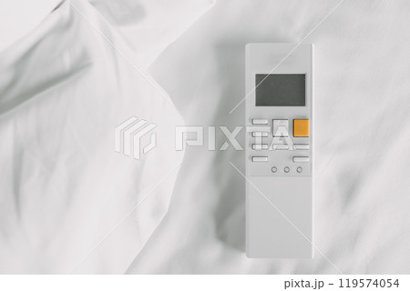 Air condition remote control on white bed sheet. Air condition remote control on white bed sheet. 119574054