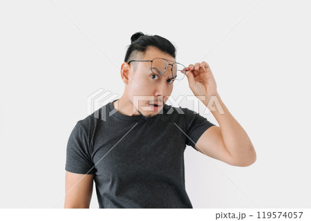 Serious angry face freelance man bun hair in black on white. 119574057